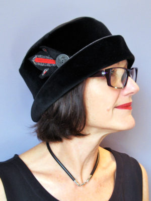 A close up of a woman wearing her black LaBijou hat.