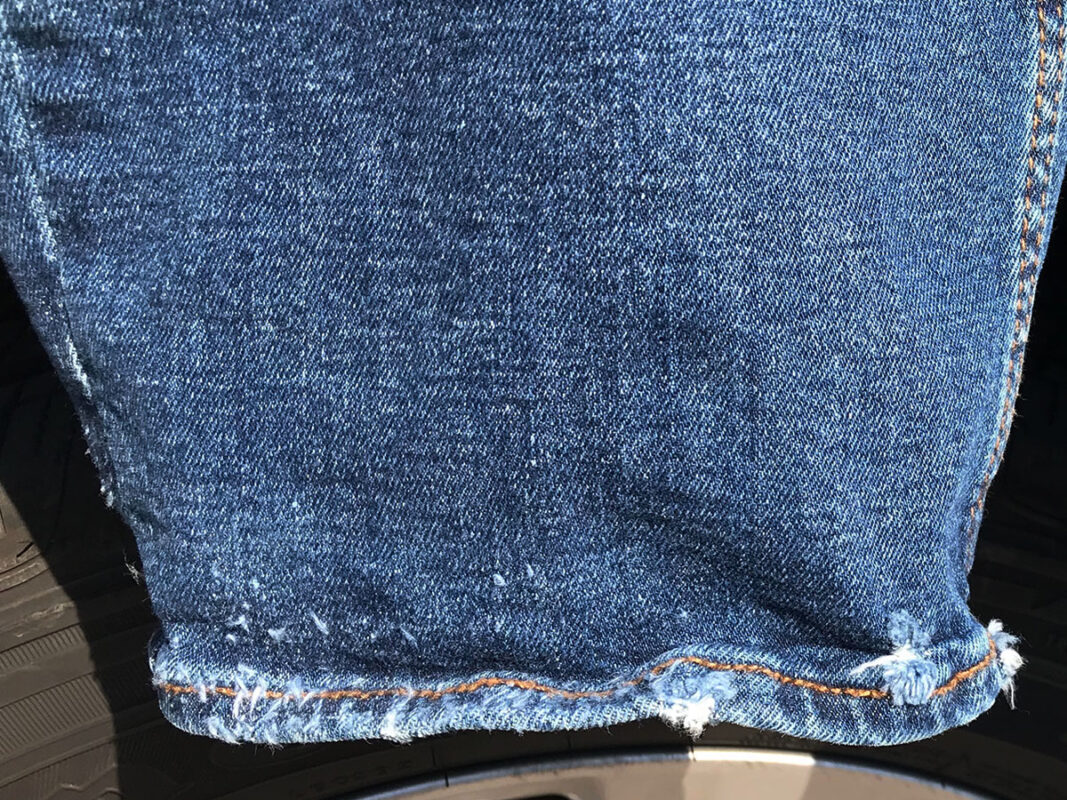 Aged detail of the jean leg bottom hem